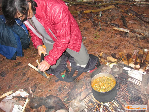 David chopping kindling for the cooking fire.