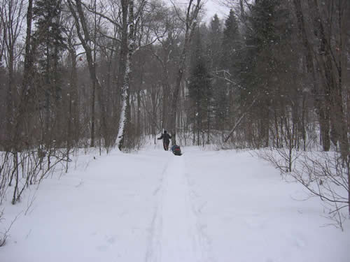 Mike snowshoeing with his two sleds.