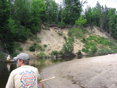 Paddling past large sandy banks.