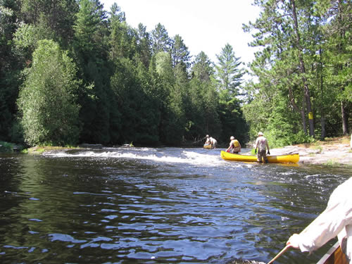 Walking the river instead of the portage.