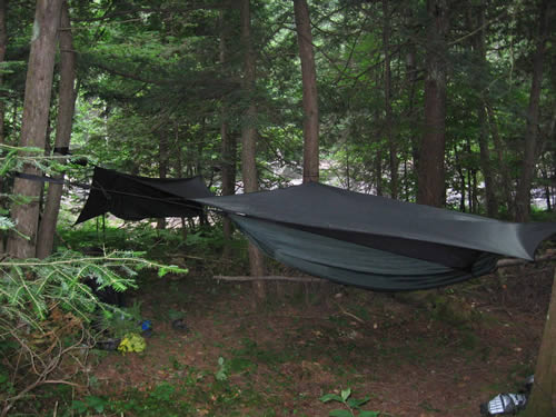 Hammocks strung next to rapids.