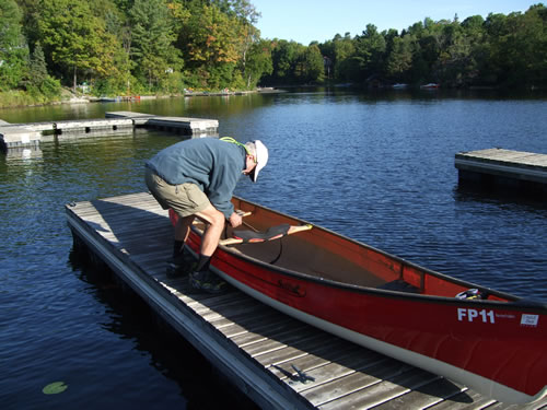 John readies the tumpline for his canoe. Only 60 portages to do.