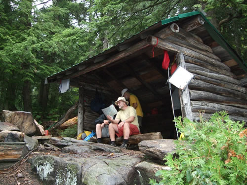 Relaxing in the comforts of a dry leanto.