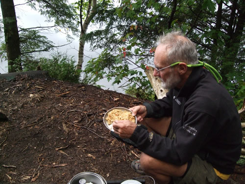 John enjoys a chicken and rice dinner.