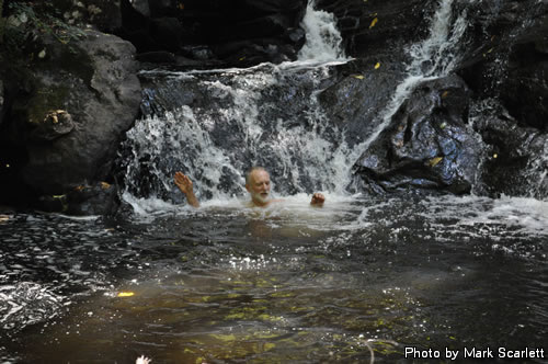 John plays in the waterfall.