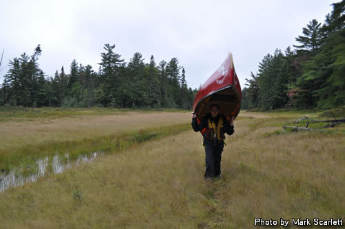 Jeff taking a turn with the canoe on the portage.