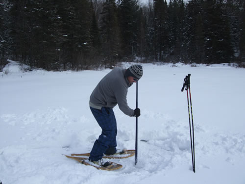 Checking ice thickness before crossing the lake.