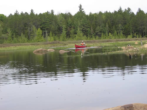 Preacher paddling past portage take-out.