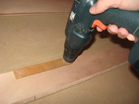 Drilling wire tie holes using a template.